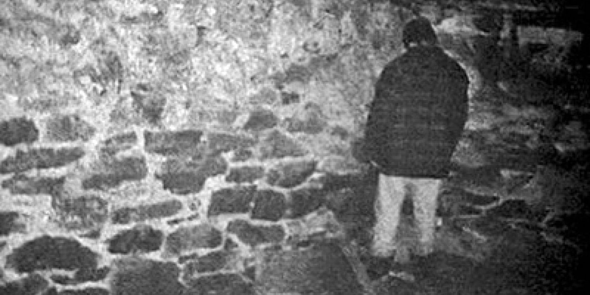 Michael Williams as Mike stands in the corner of a basement in The Blair Witch Project (1999)