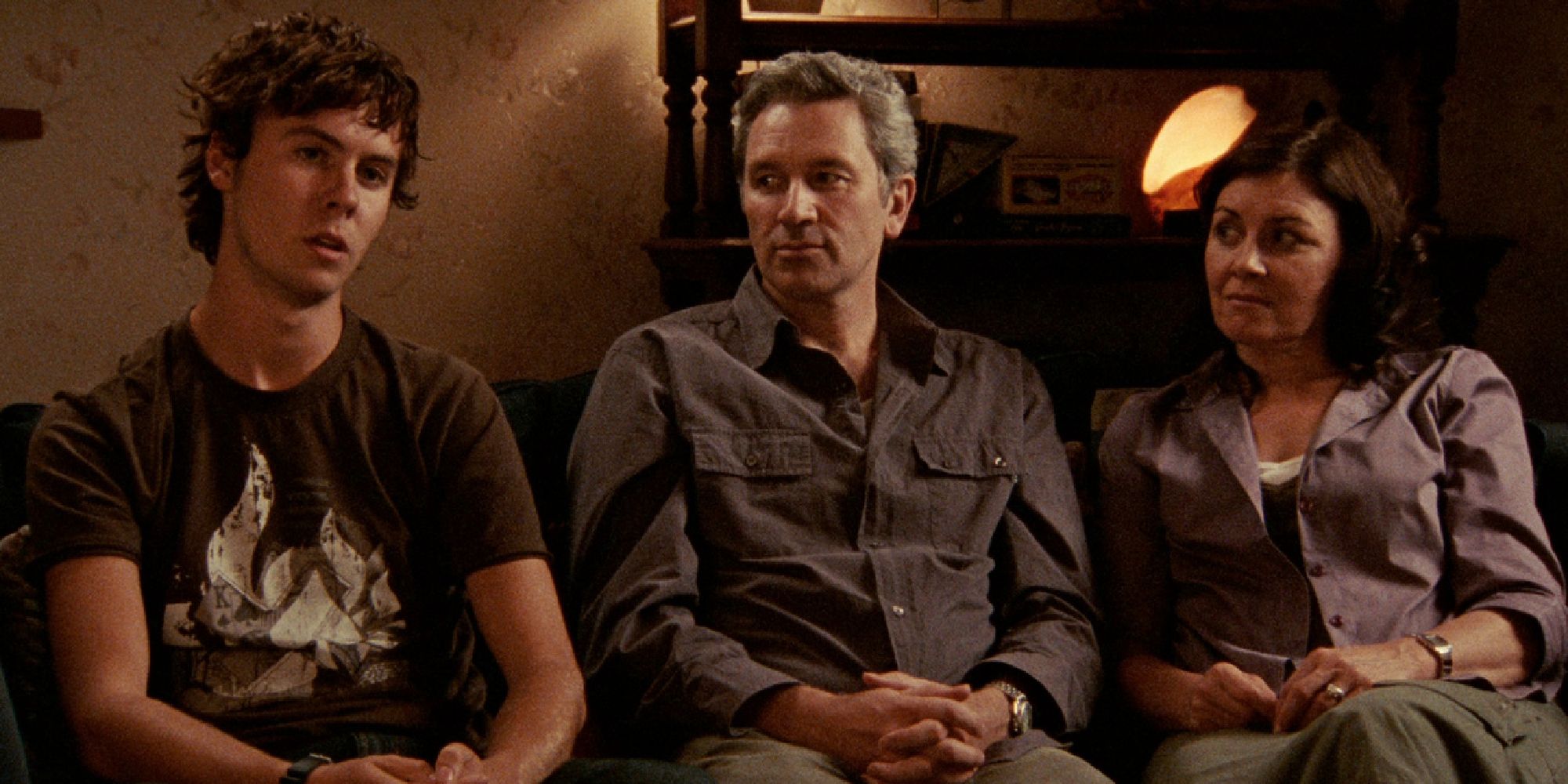 The cast of Lake Mungo sitting on a couch and talking to the camera