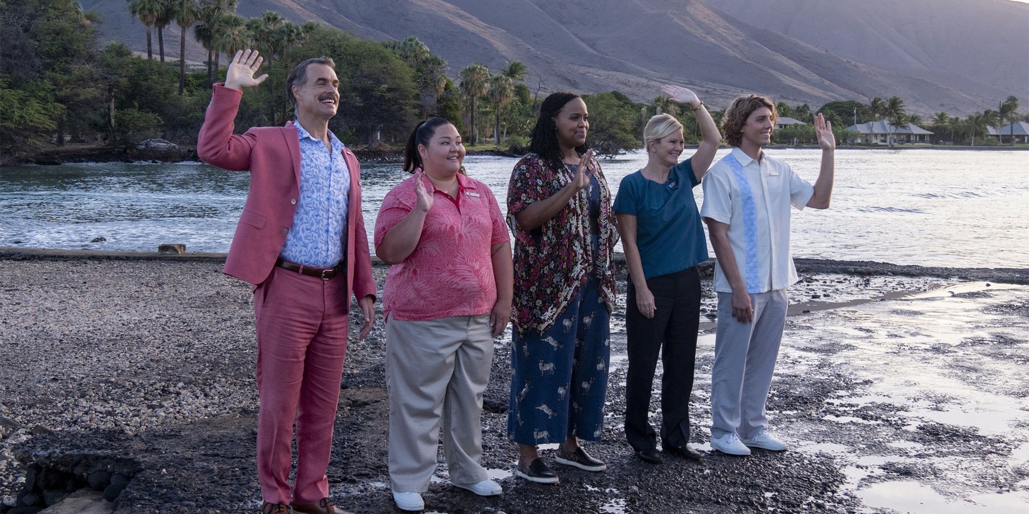 The cast of Season 1 waving on a beach in The White Lotus.