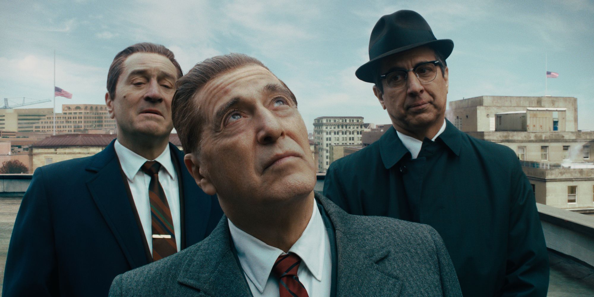 Jimmy Hoffa (Al Pacino) and two of his associates look up at a sign in 'The Irishman'.