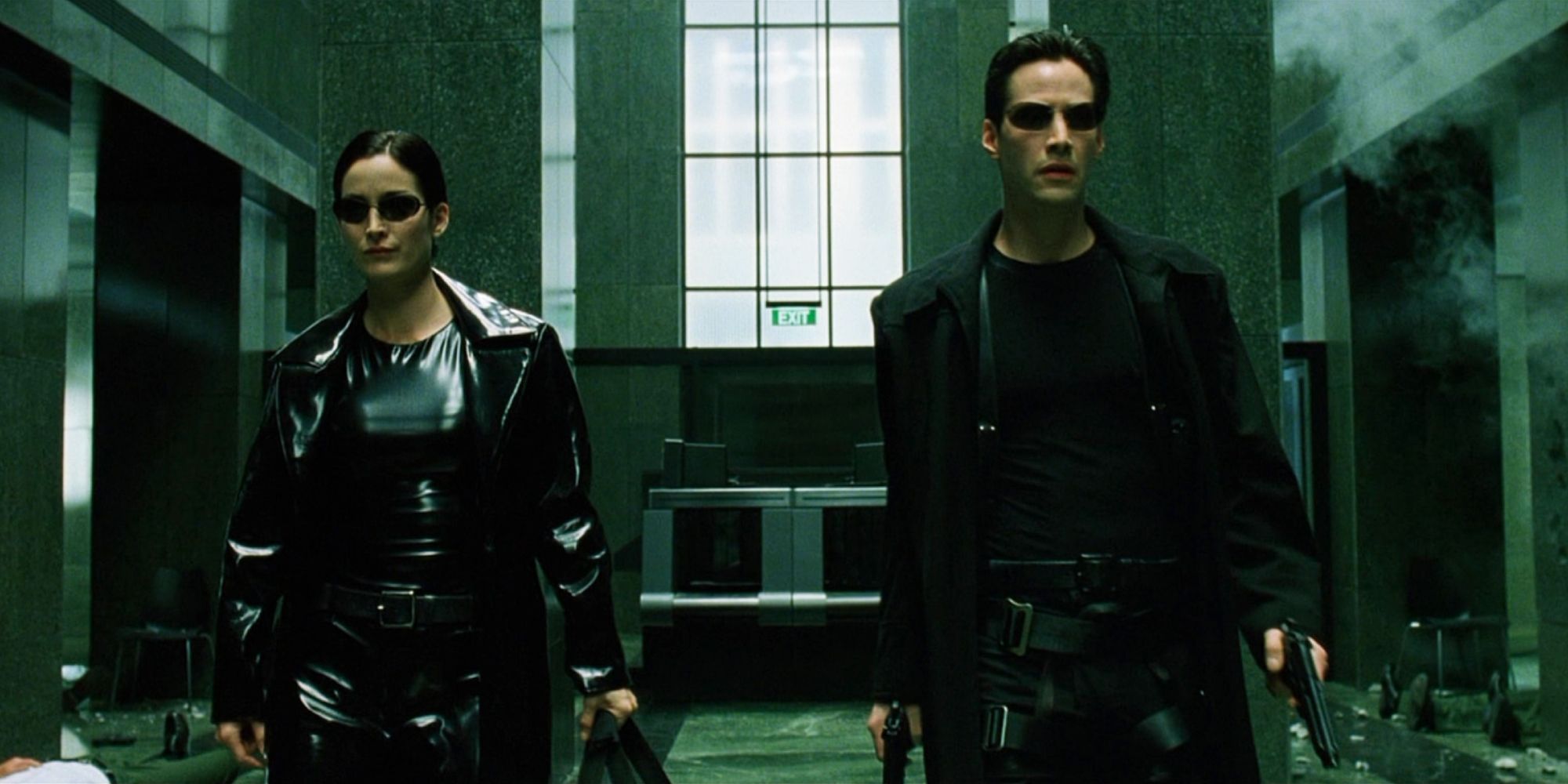 Neo, played by Keanu Reeves, and Trinity, played by Carrie-Anne Moss, walk intently in 'The Matrix'.