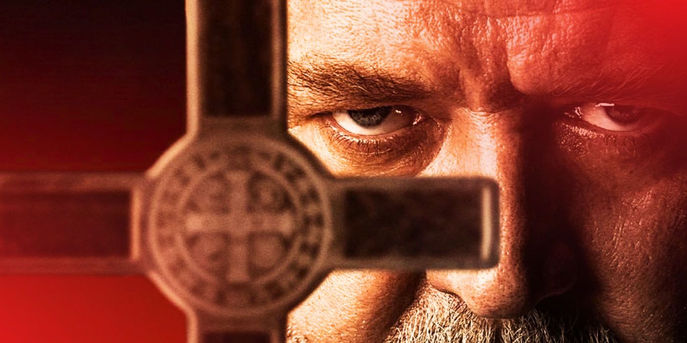 A close-up of Russell Crowe holding up a crucifix in The Pope's Exorcist