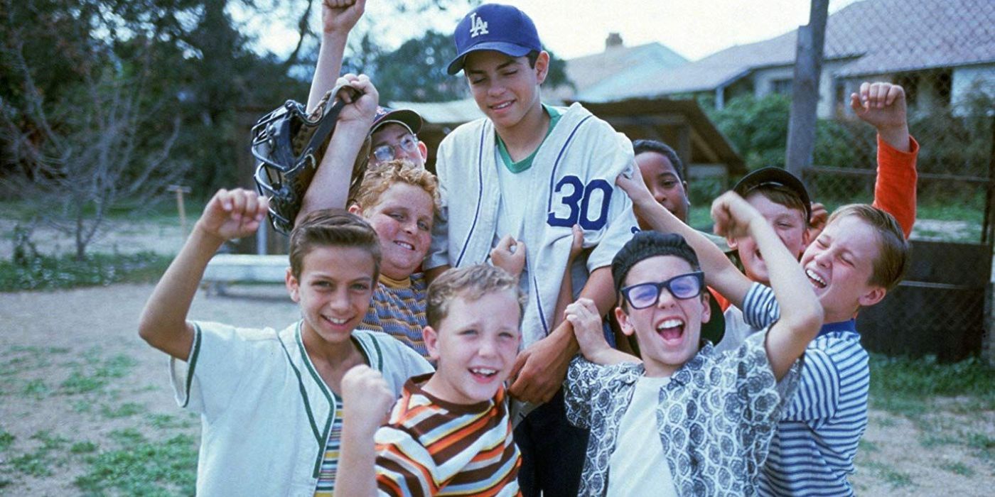 The boys of The Sandlot cheering and holding up Benny, played by Mike Vitar
