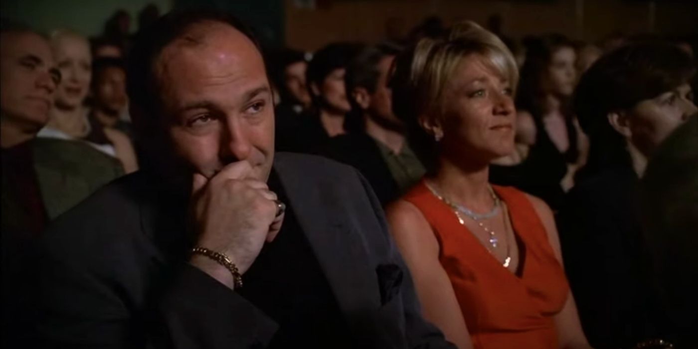 James Gandolfini and Edie Falco sitting next to each other watching a performance in The Sopranos