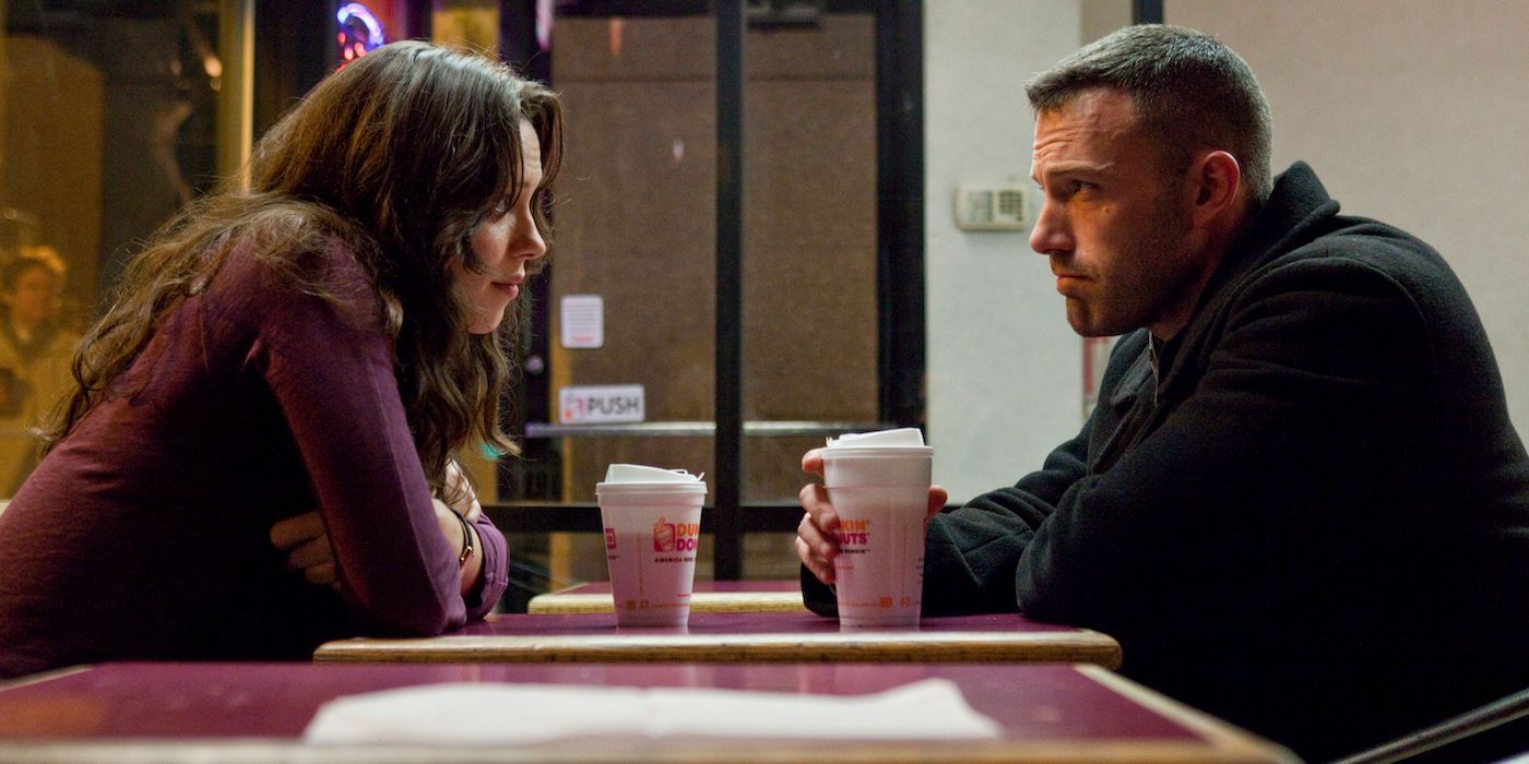 Ben Affleck and Rebecca Hall sitting in a Dunkin' in The Town