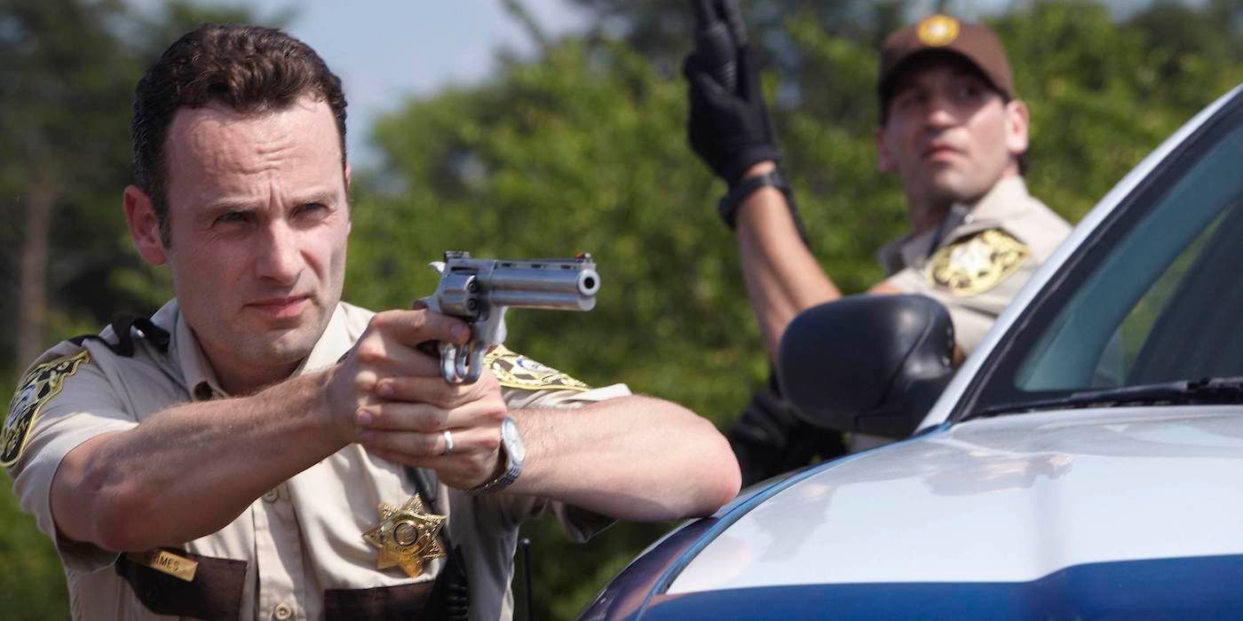 Andrew Lincoln and Jon Bernthal in sheriff's uniforms holding guns in The Walking Dead Pilot. 