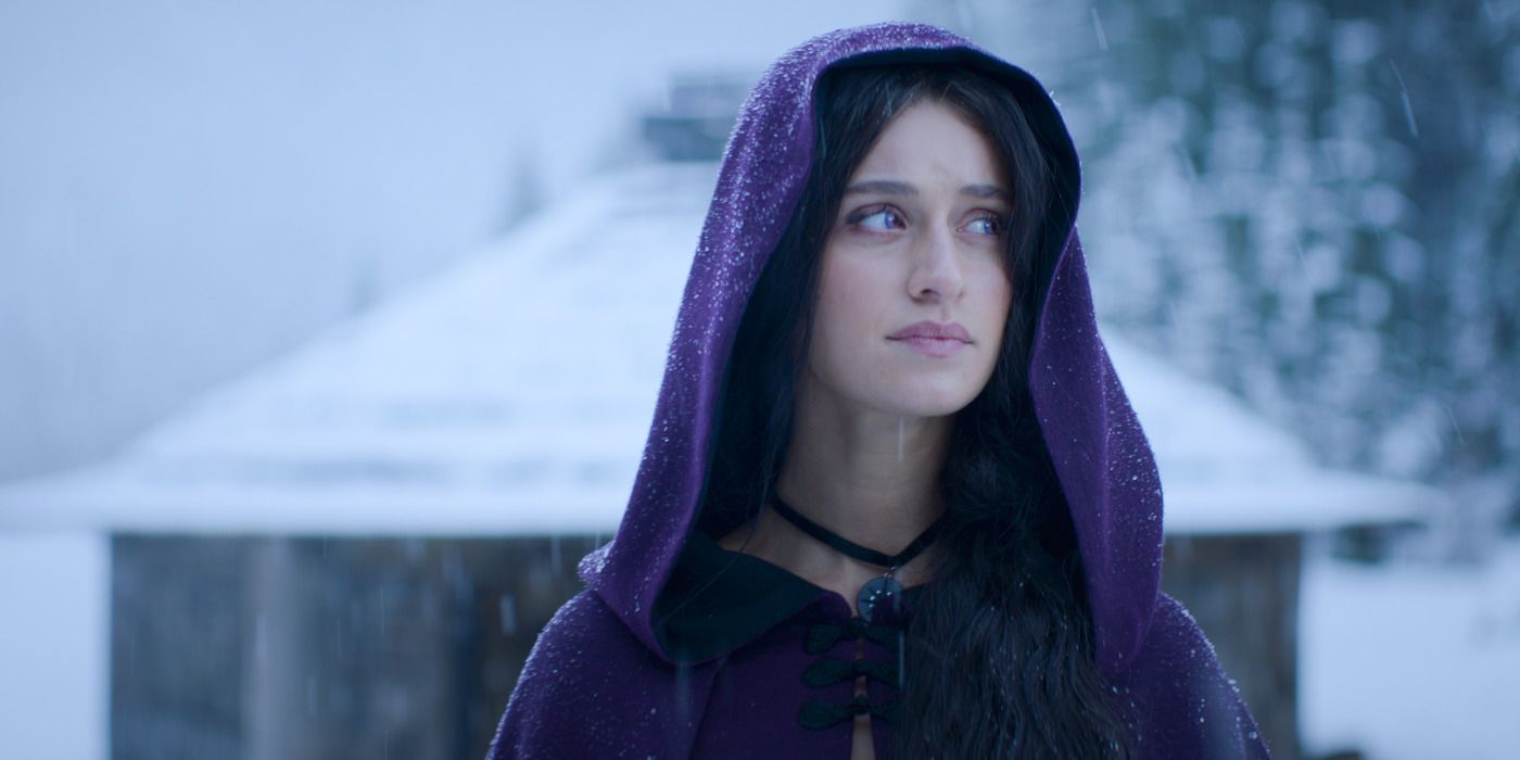 Anya Chalotra as Yennefer of Vengerberg wearing a purple hood in The Witcher.