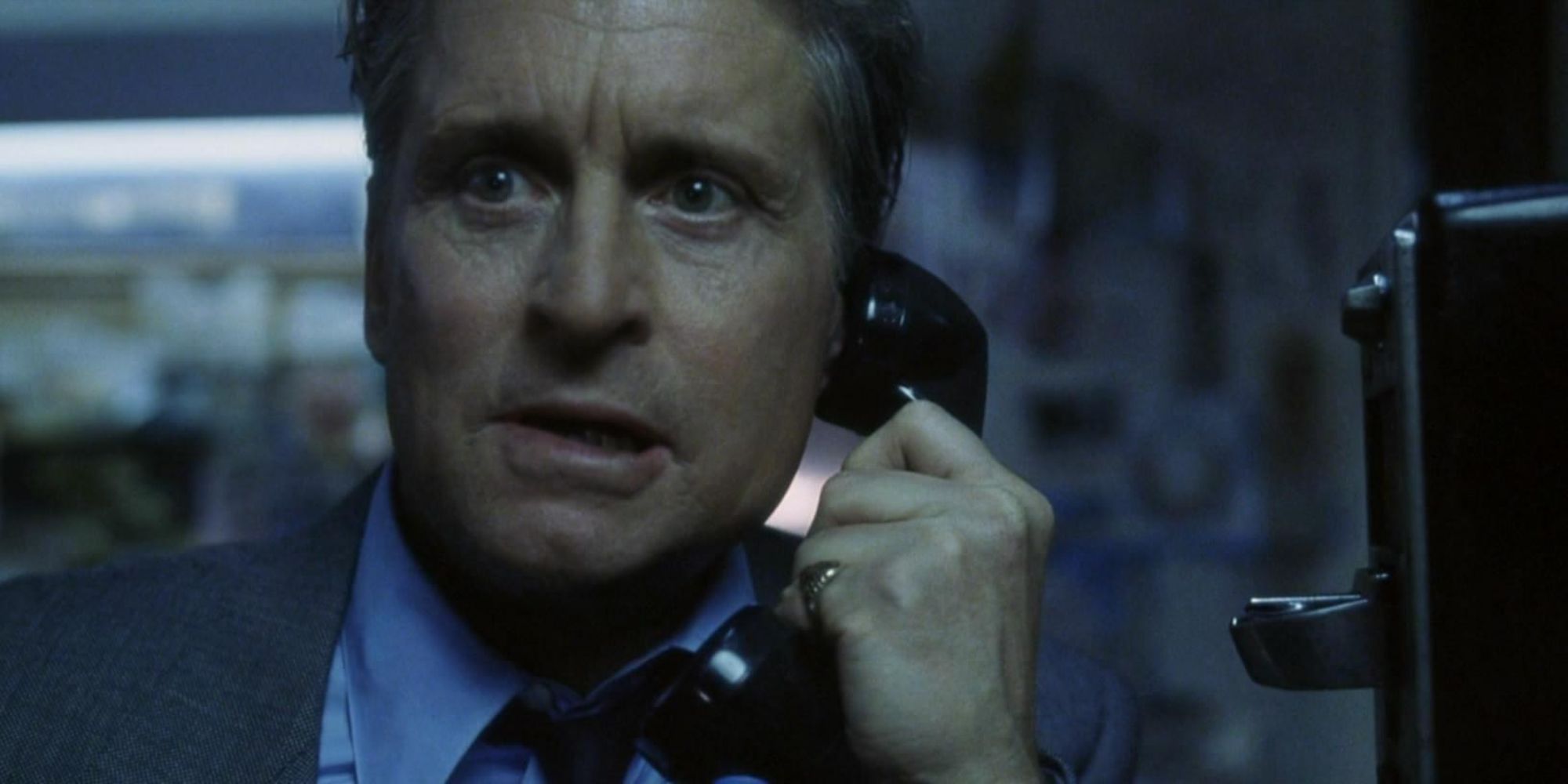 A man talks on a payphone