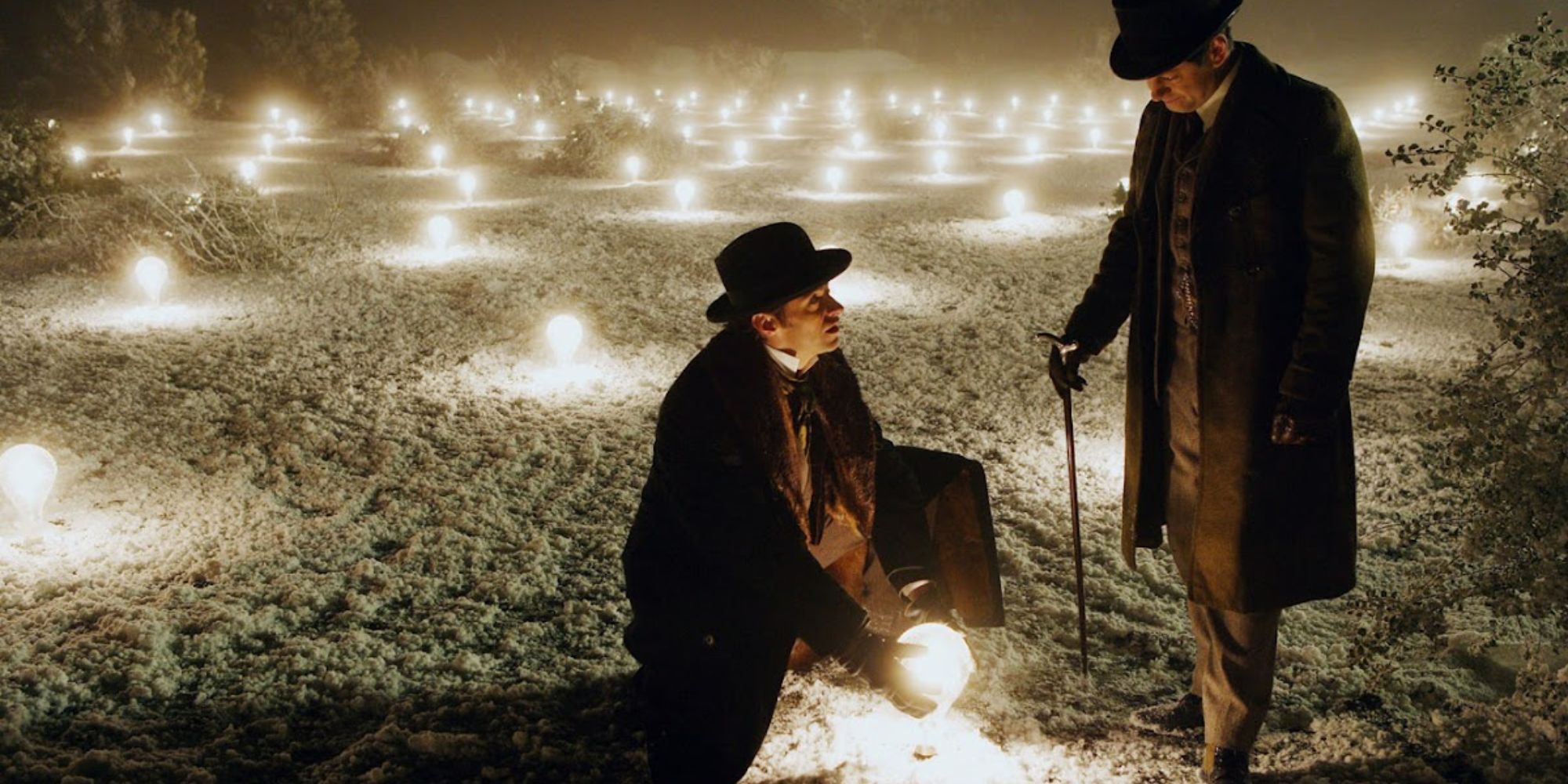 A magician and a scientist's assistant stand in a field of lights in 'The Prestige'.