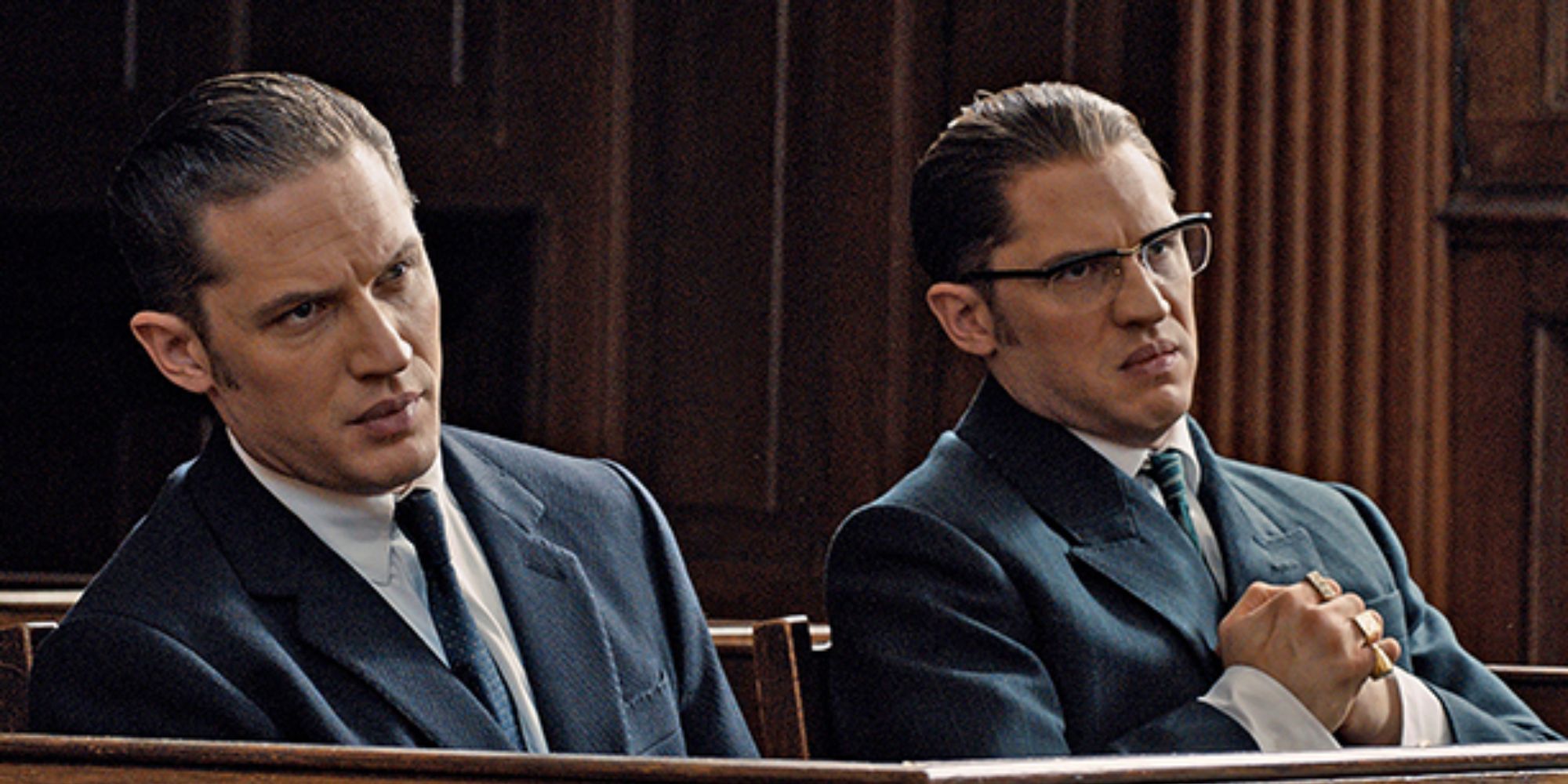 The Kray brothers sitting next to each other at court in Legend.