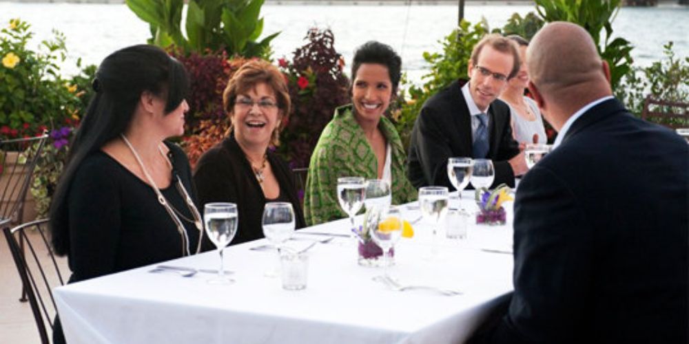 Top Chef judges and guests dine at a table outside on Ellis Island