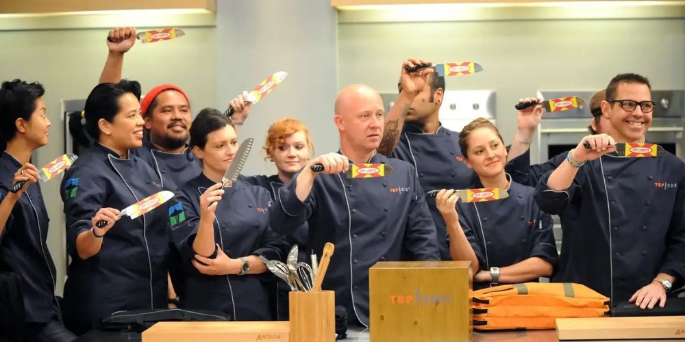The chefs competing in Top Chef Seattle hold up their knives