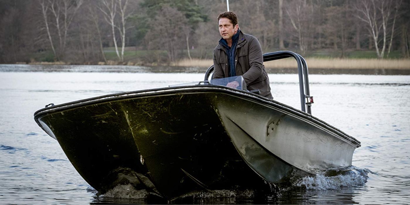 Gerard Butler as Mike Banning driving a boat down a river in Angel Has Fallen