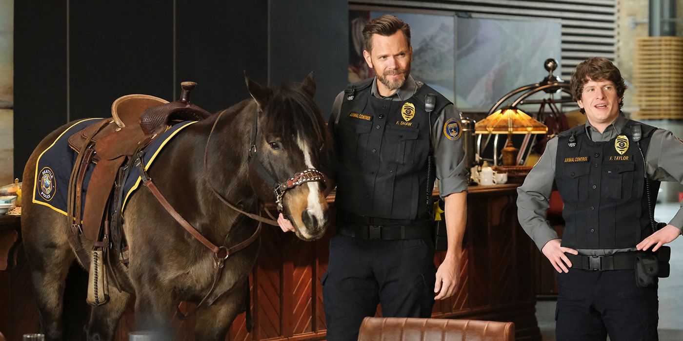 Joel McHale and Michael Rowland help a horse in a scene from Animal Control