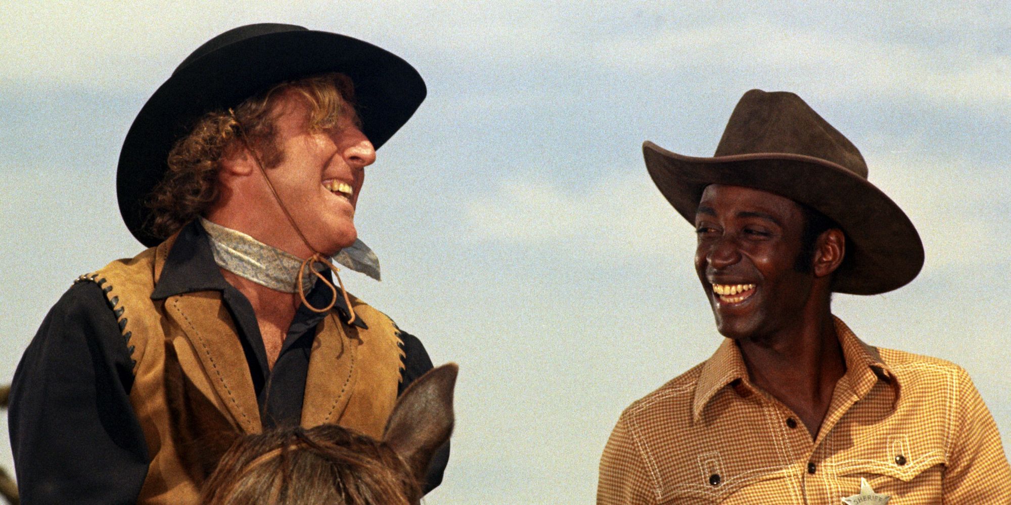 Jim the Waco Kid and Sheriff Bart smiling to each other in Blazing Saddles