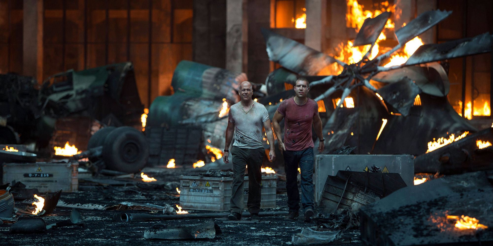 Bruce Willlis and Jai Courtney in 'A Good Day to Die Hard' walking away from an exploded helicopter