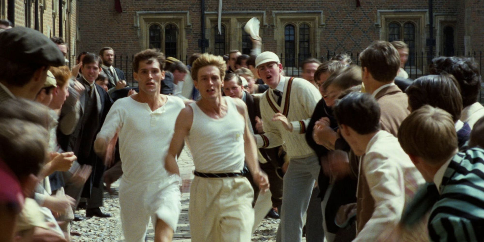 Men running with crowds cheering them on in Chariots of Fire.