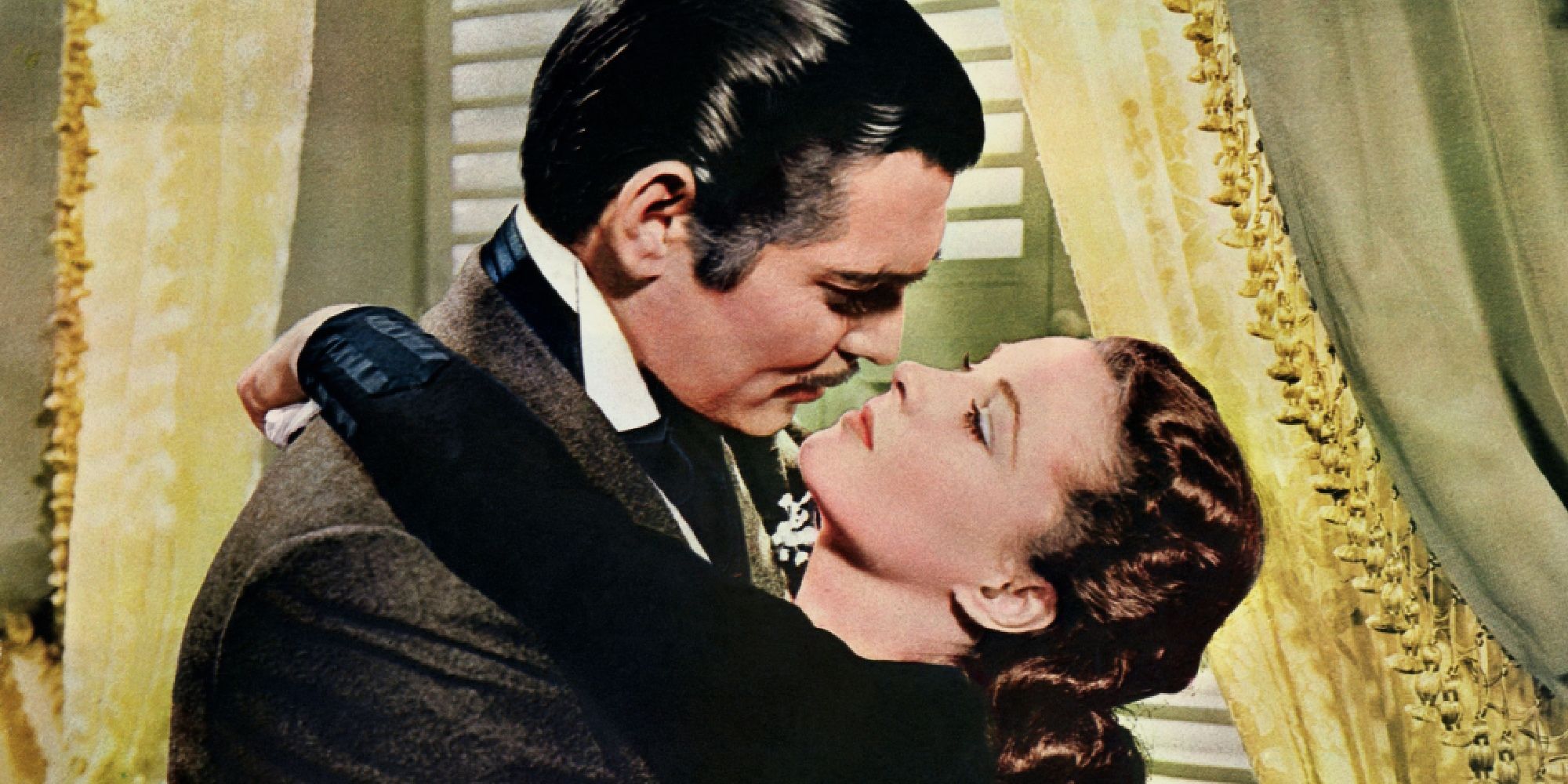 Rhett and Scarlet embracing and about to kiss in Gone with the Wind
