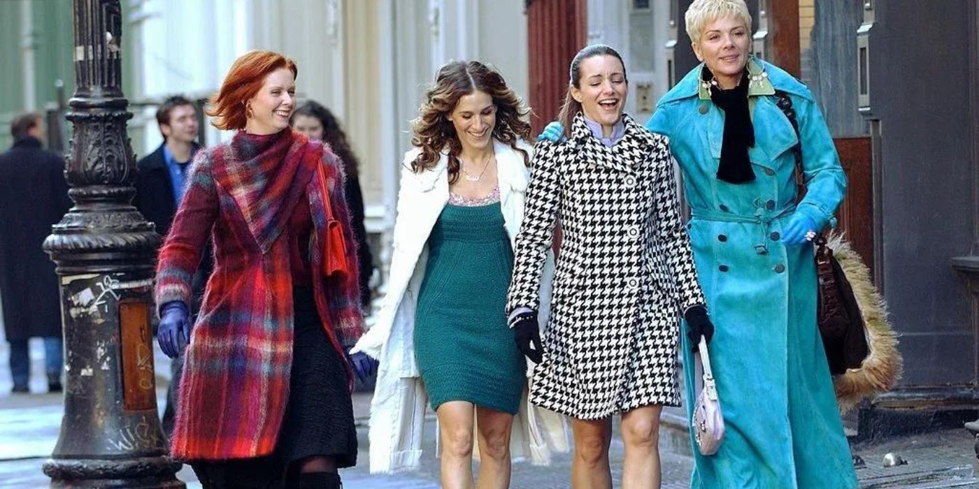 The main characters from Sex and the City walking down the street and laughing.