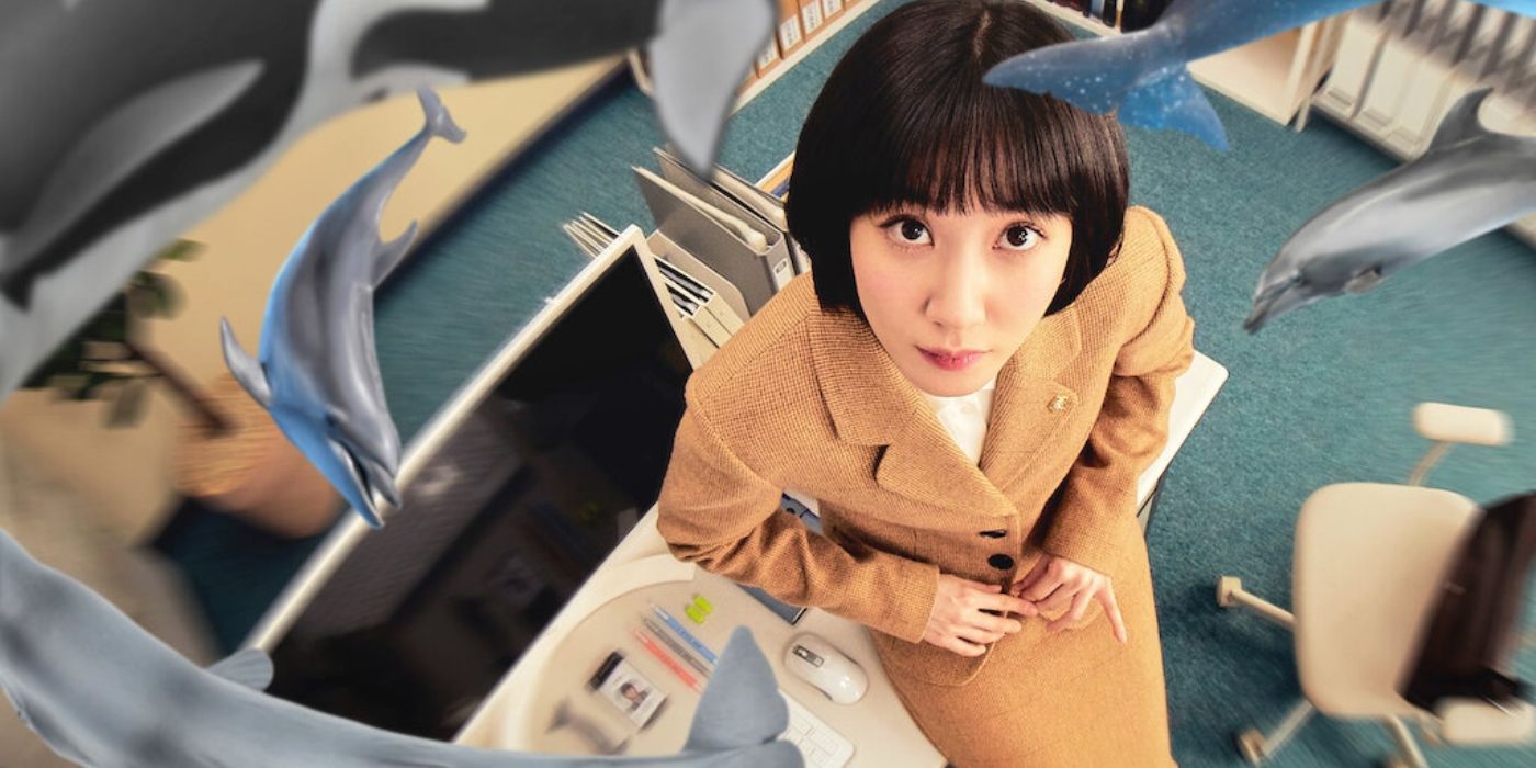 Park Eun-bin with whales and dolphins circling around her on Extraordinary Attorney Woo. 