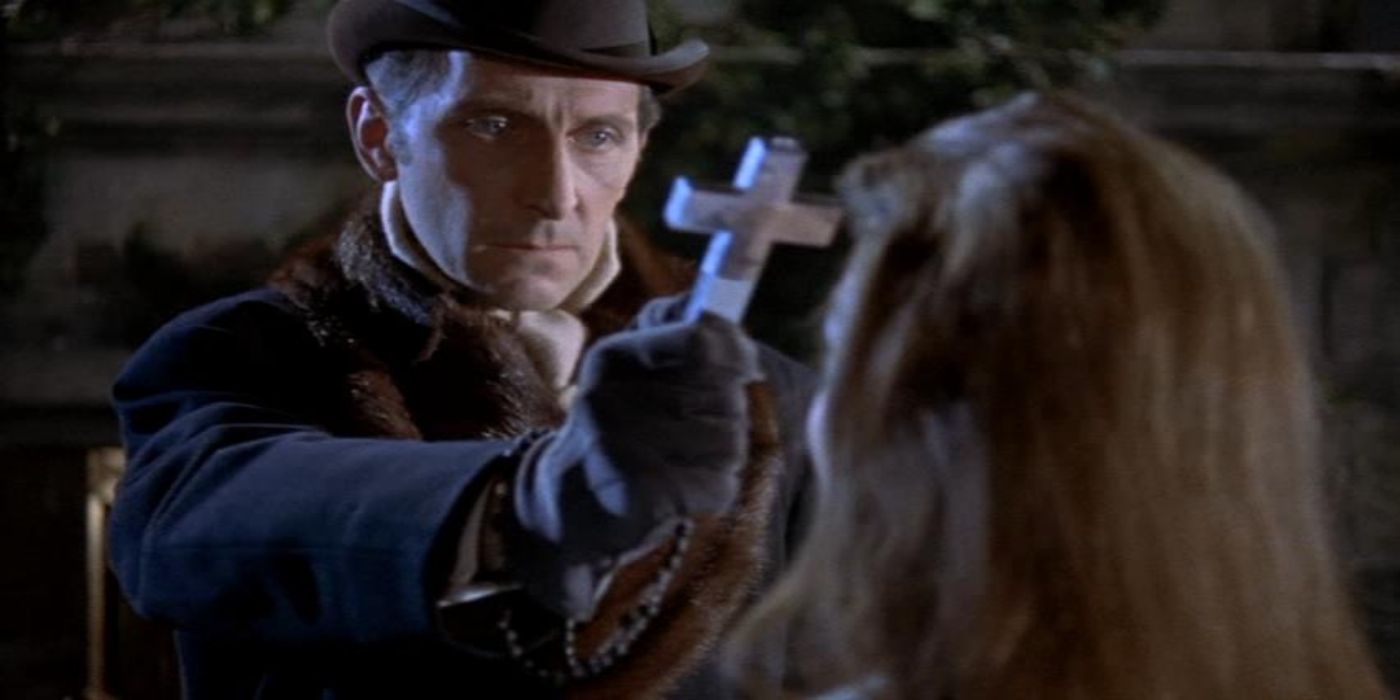 Peter Cushing as Van Helsing holding out a crucifix in Dracula