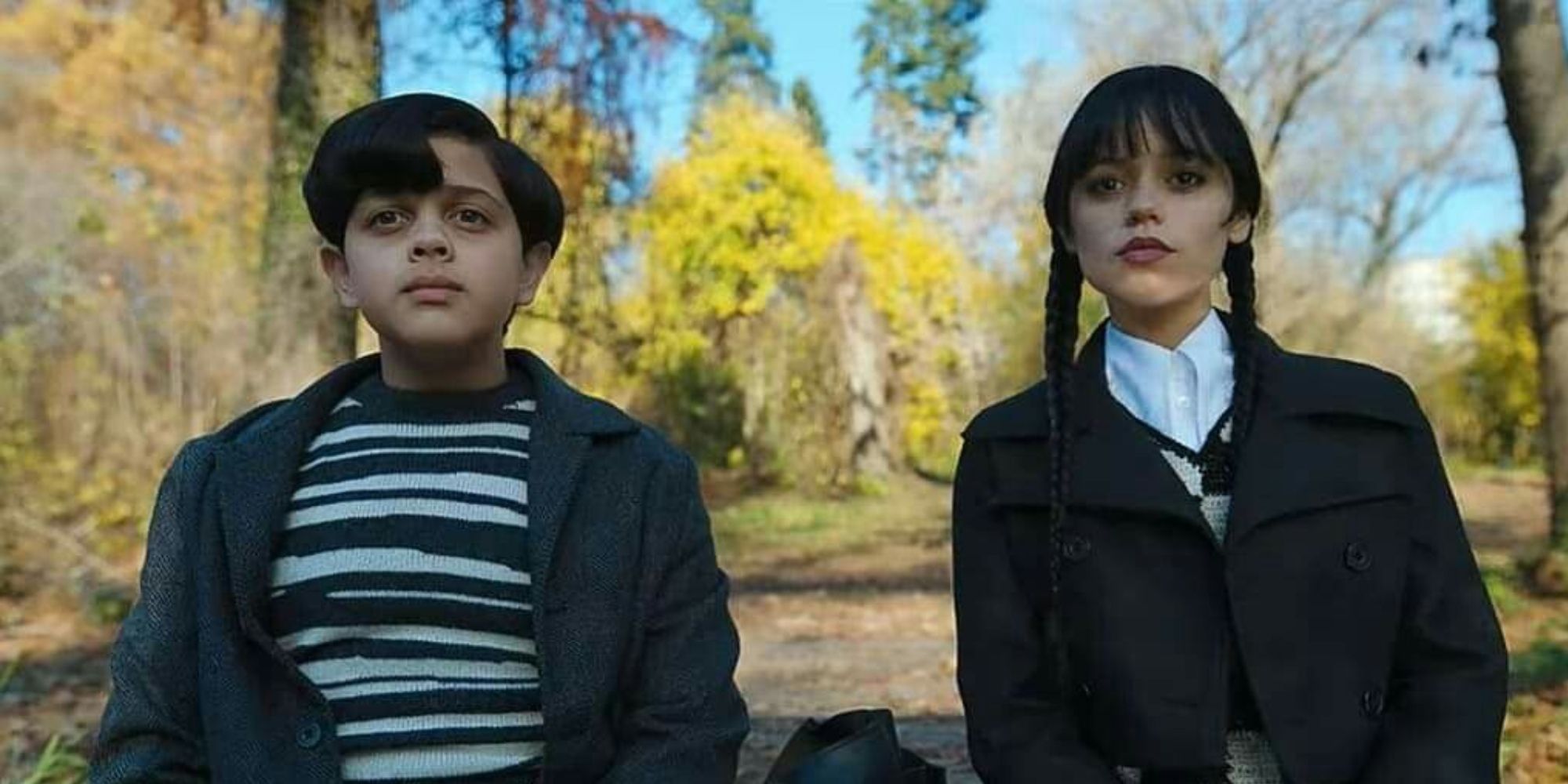 Isaac Ordonez and Jenna Ortega as Pugsley and Wednesday looking ahead in Wednesday