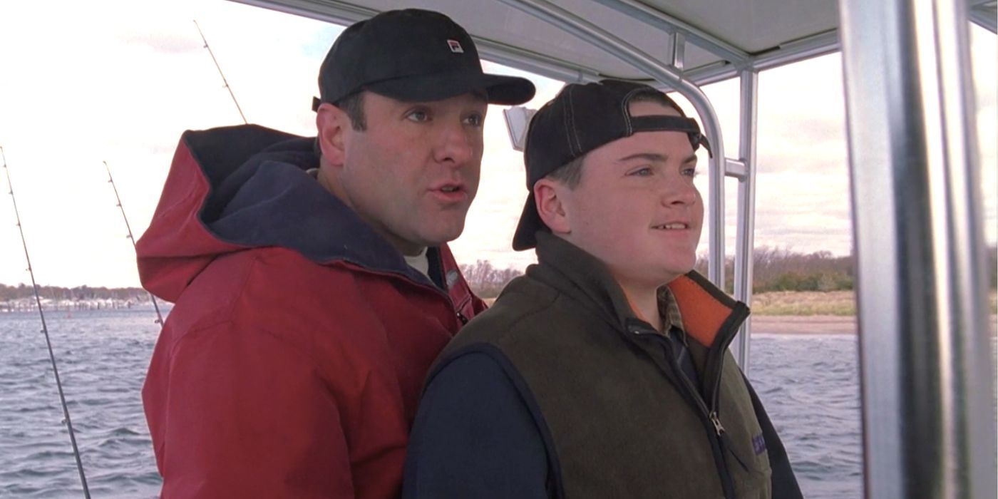 James Gandolfini standing behind Robert Iler while he sails their boat in The Sopranos