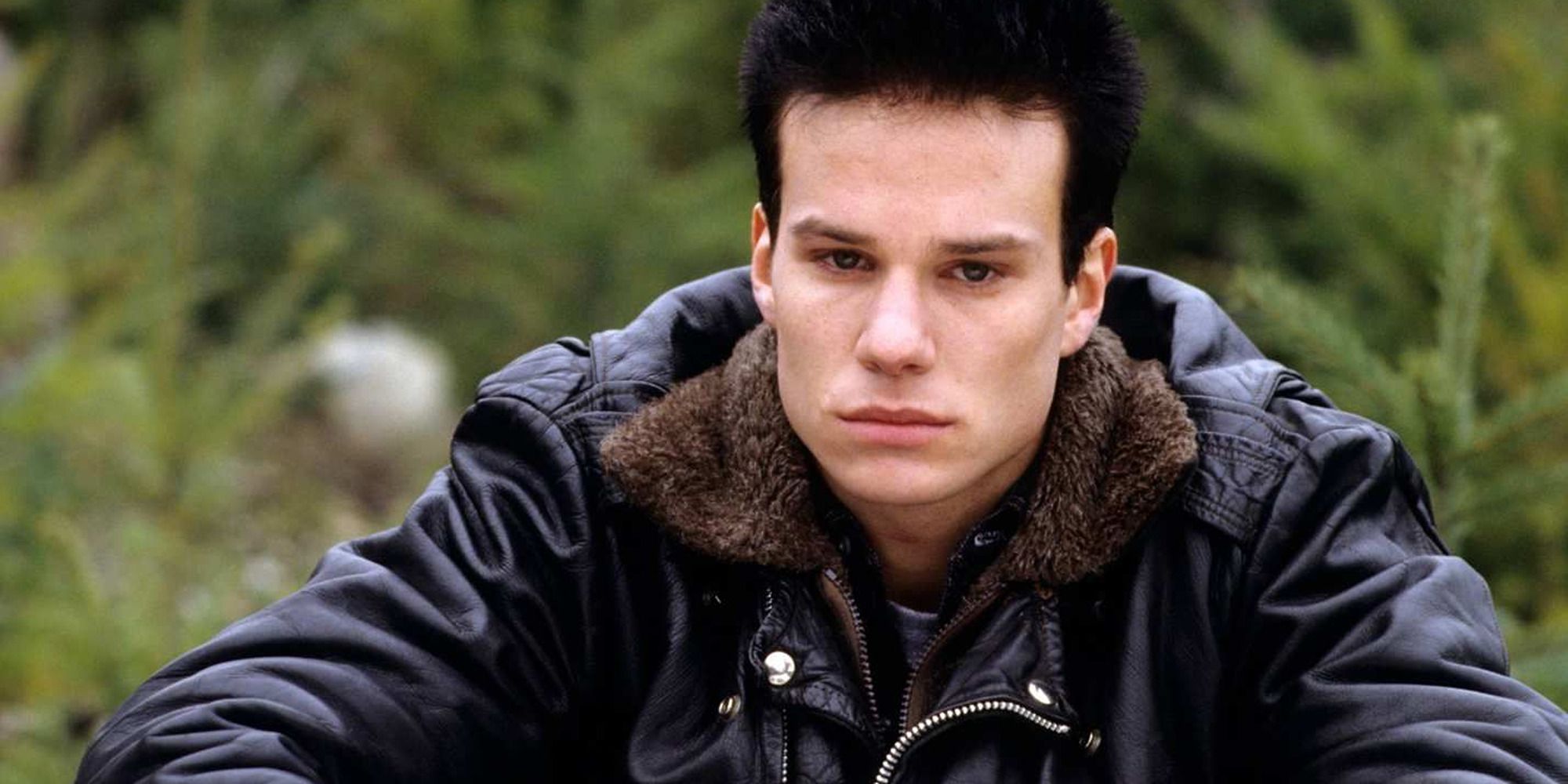 James Marshall as James Hurley in 'Twin Peaks', sitting on the grass, sad