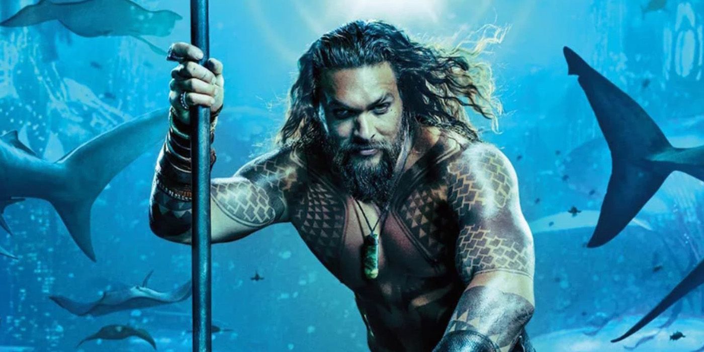 Jason Momoa as Aquaman swimming with the sharks.