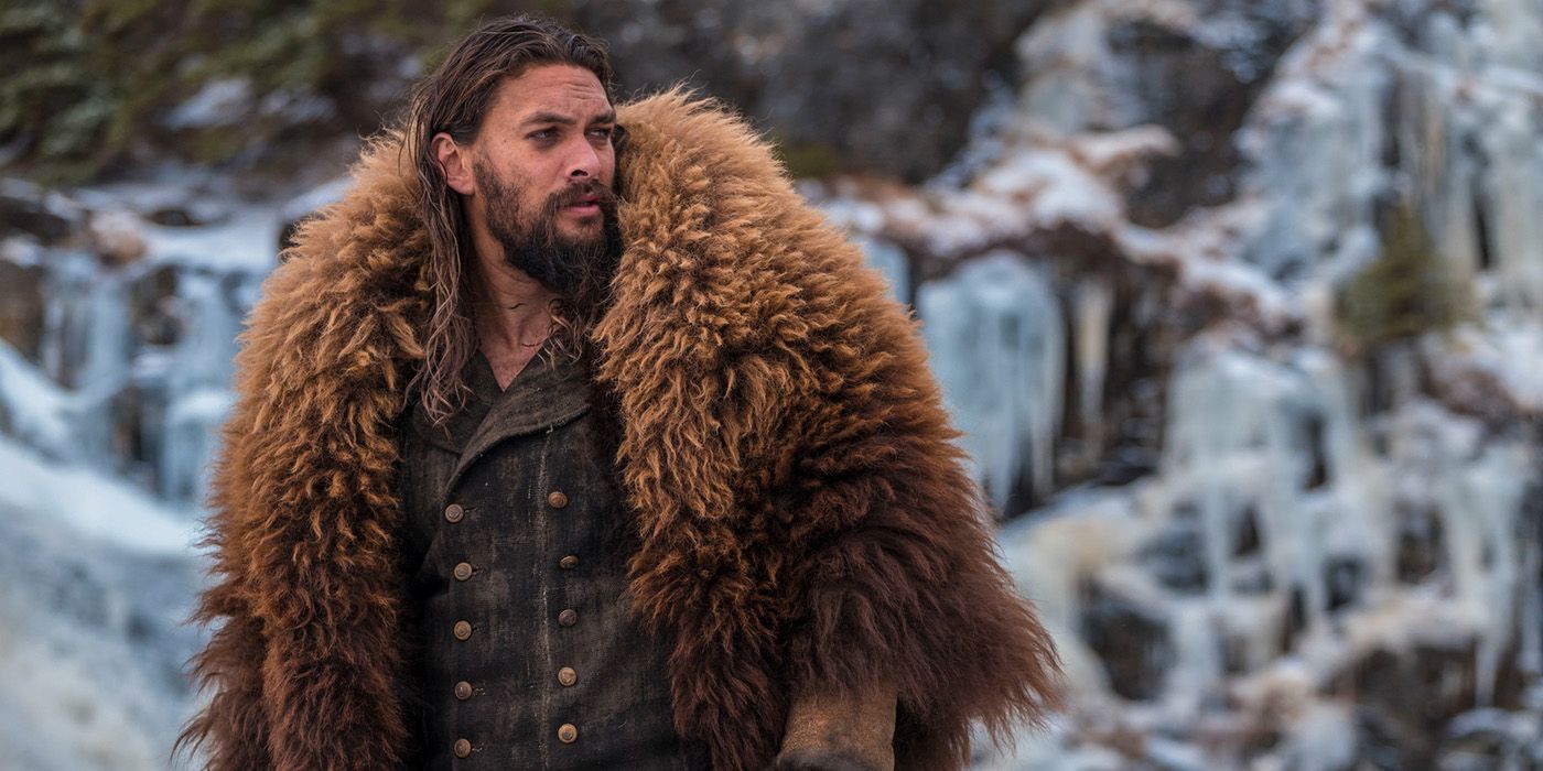 Jason Momoa in a big fur jacket looking off to the side in a scene from Frontier.