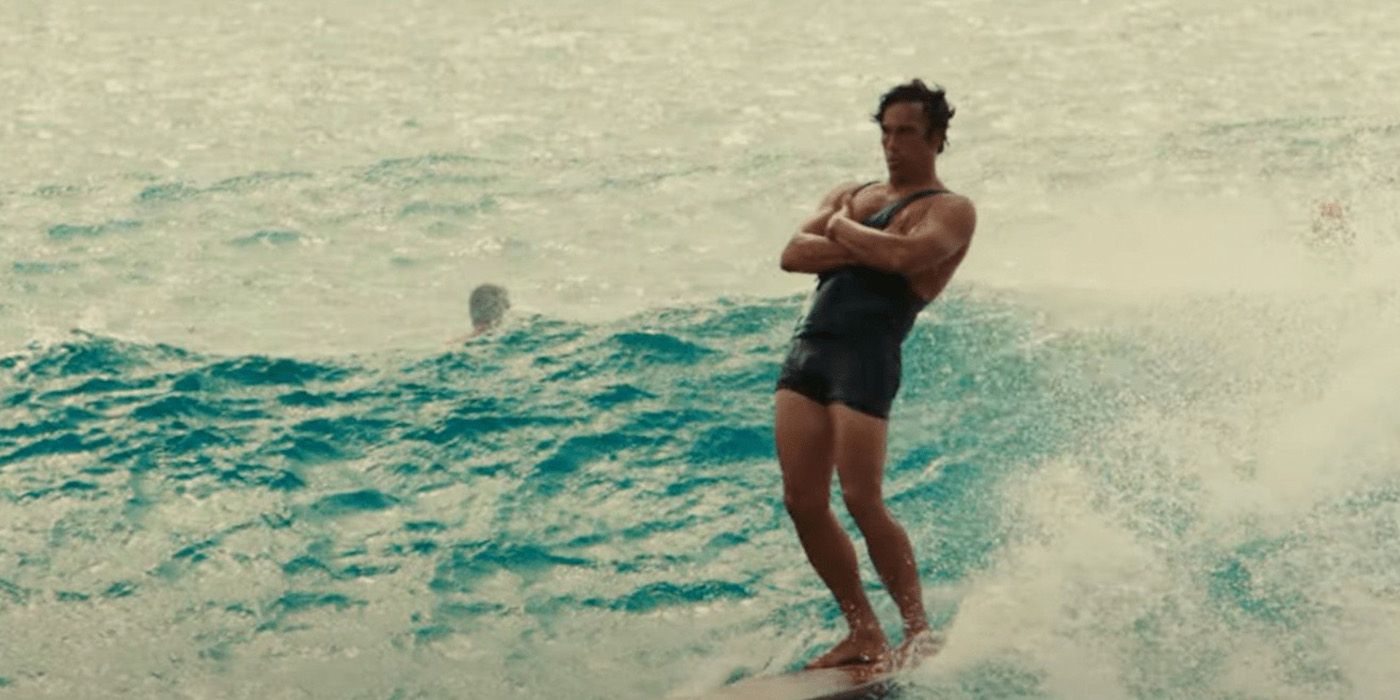 A man surfing with his arms folded in front of him in a scene from Waterman.