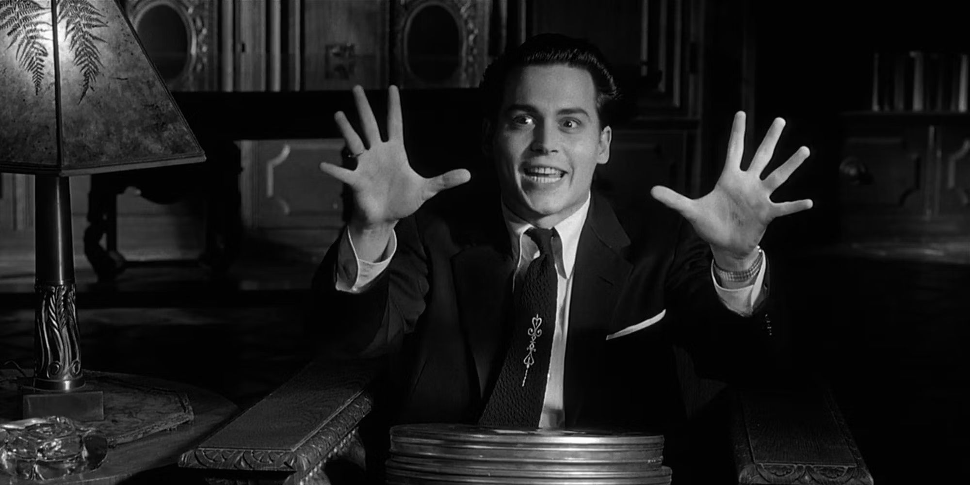 Johnny Depp as Ed Wood making a movement with his hands while smiling