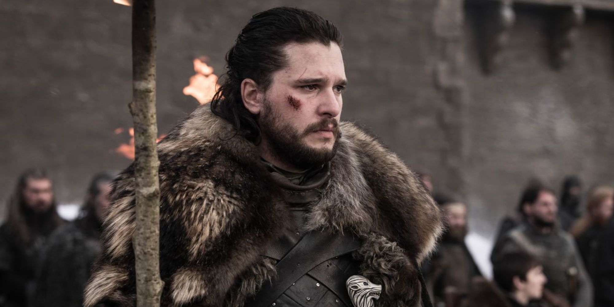 Kit Harington as Jon Snow looking solemn while at a funeral in Game of Thrones.