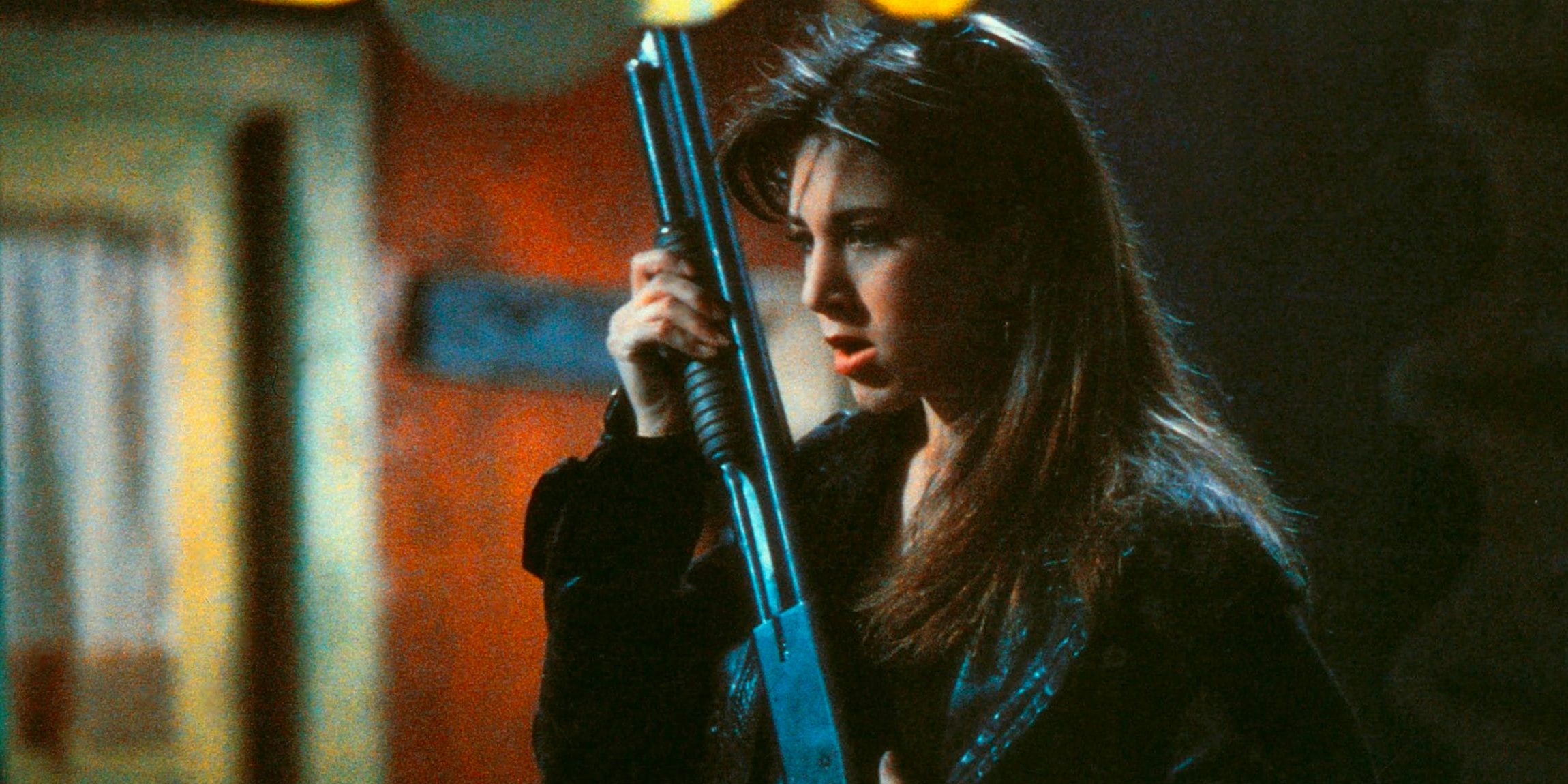 Tory Redding (Jennifer Aniston) wields a pump-action shotgun in 'Leprechaun'. 