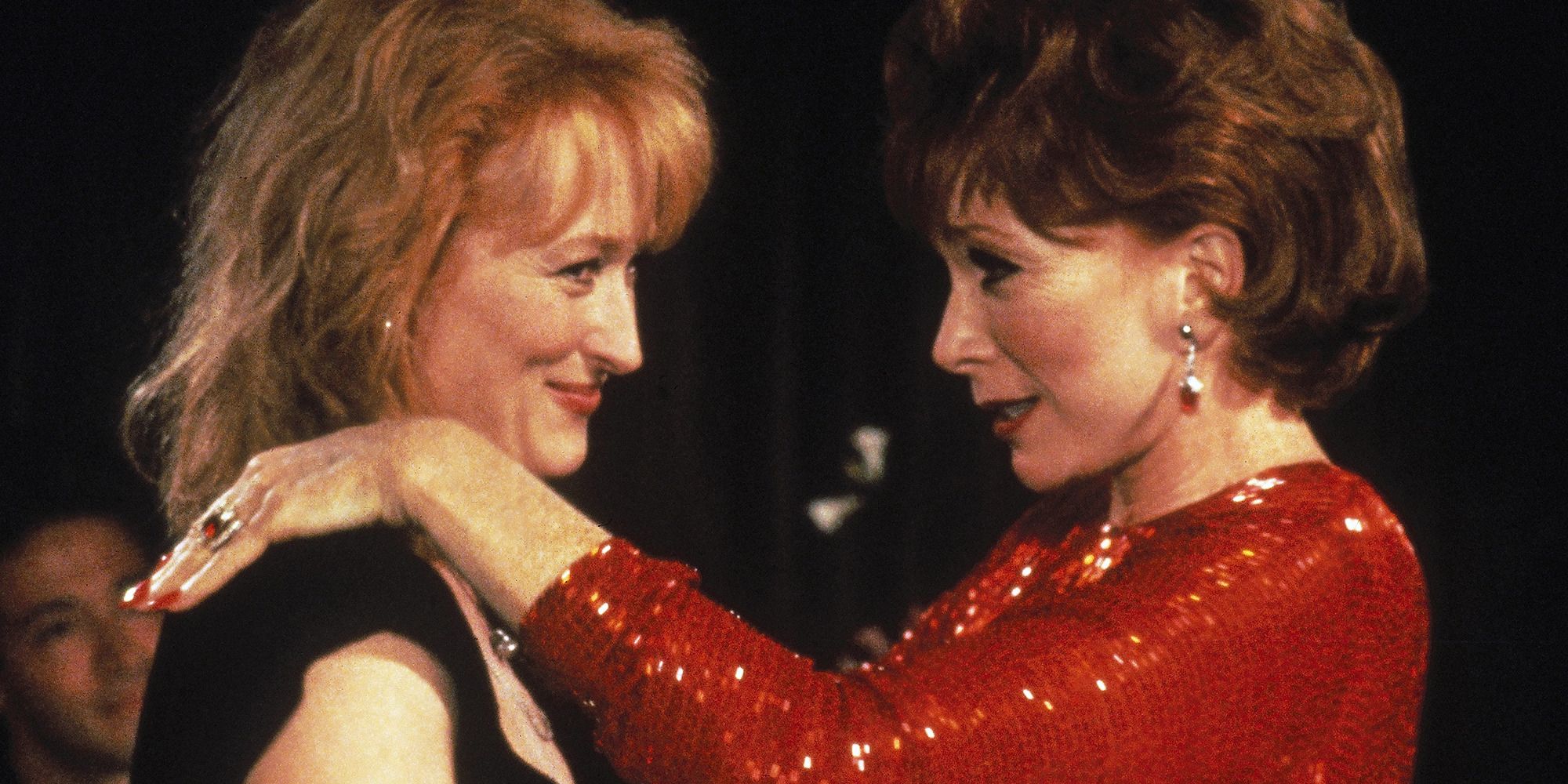 Meryl Streep and Shirley MacLaine in 'Postcards from the Edge', smiling and embracing