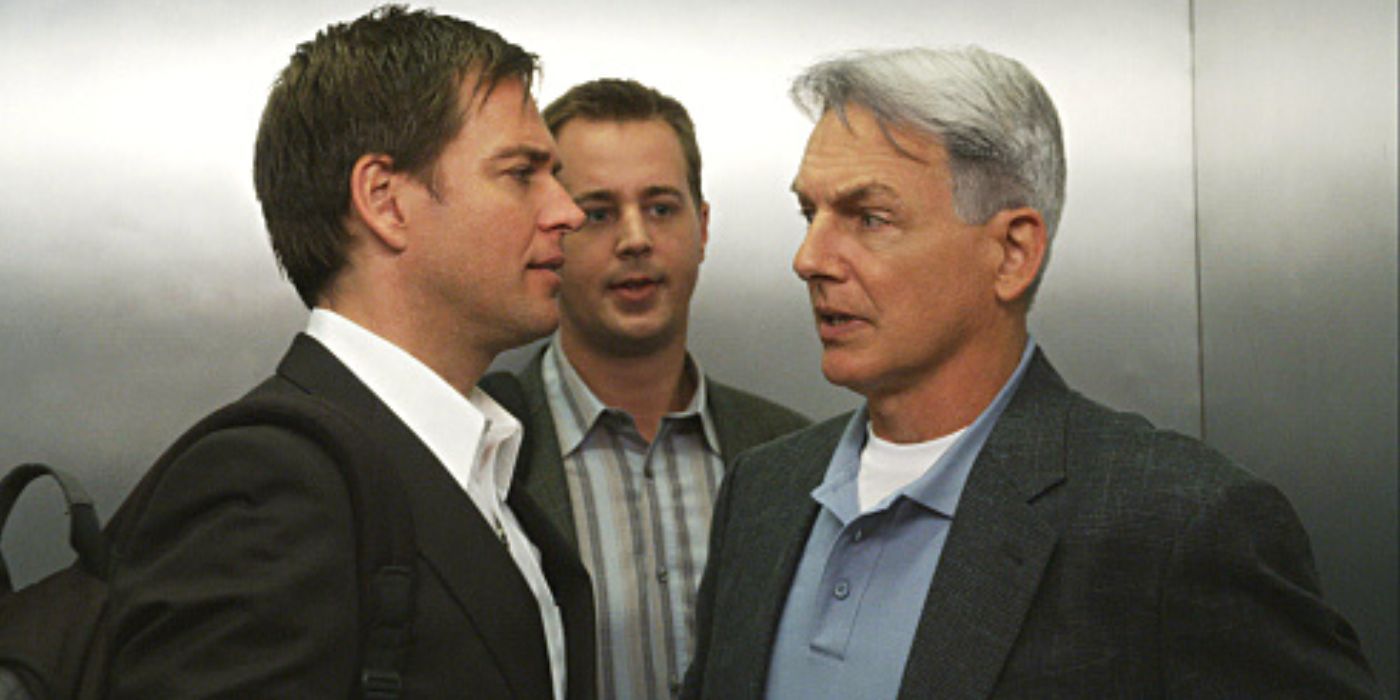 Michael Weatherly and Mark Harmon talking in an elevator with Sean Murray standing behind them in NCIS