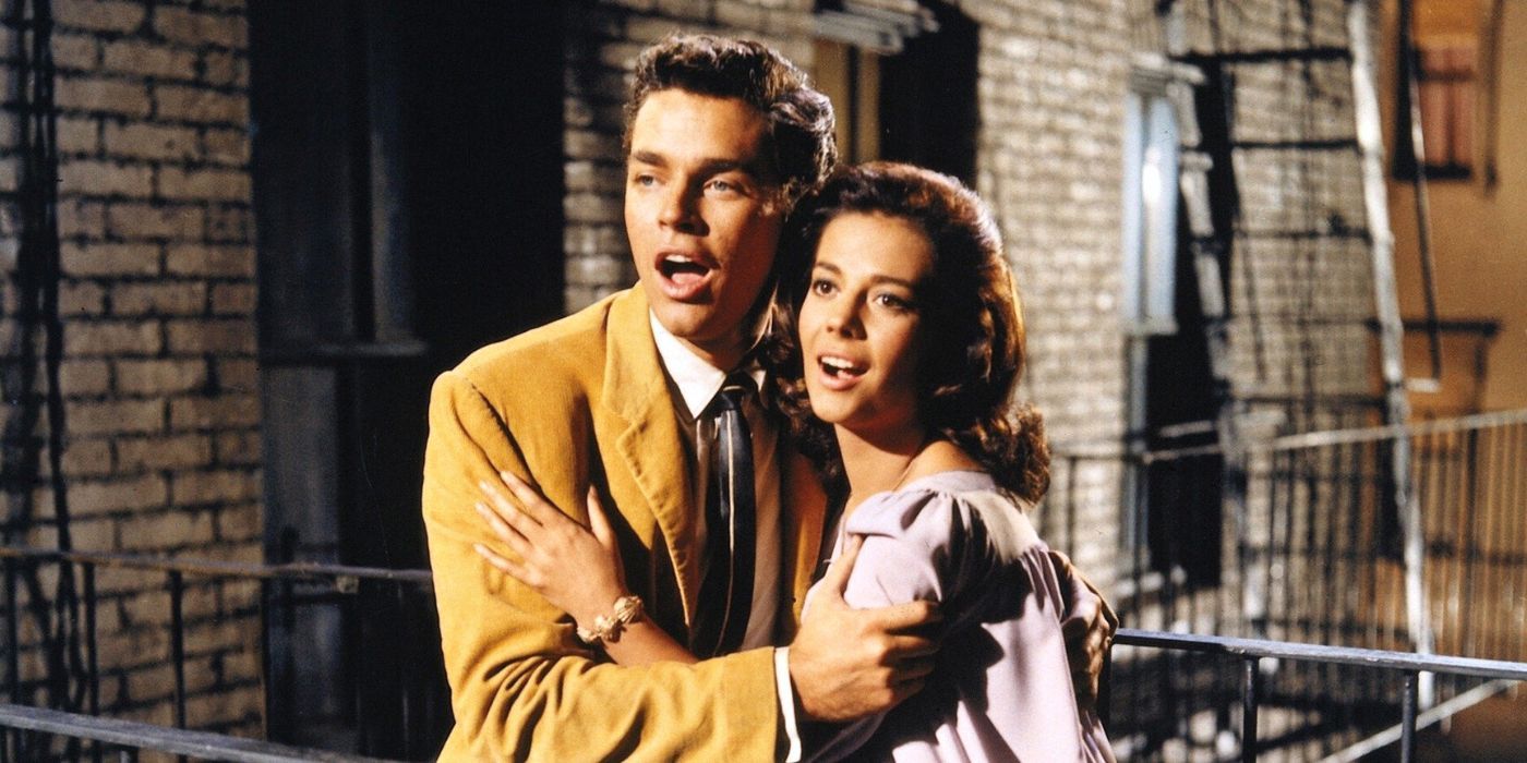 Natalie Wood and Richard Beymer holding each other while singing in West Side Story