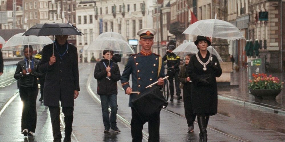 Royal family walking in the streets of Amsterdam in Steve McQueen's Occupied City