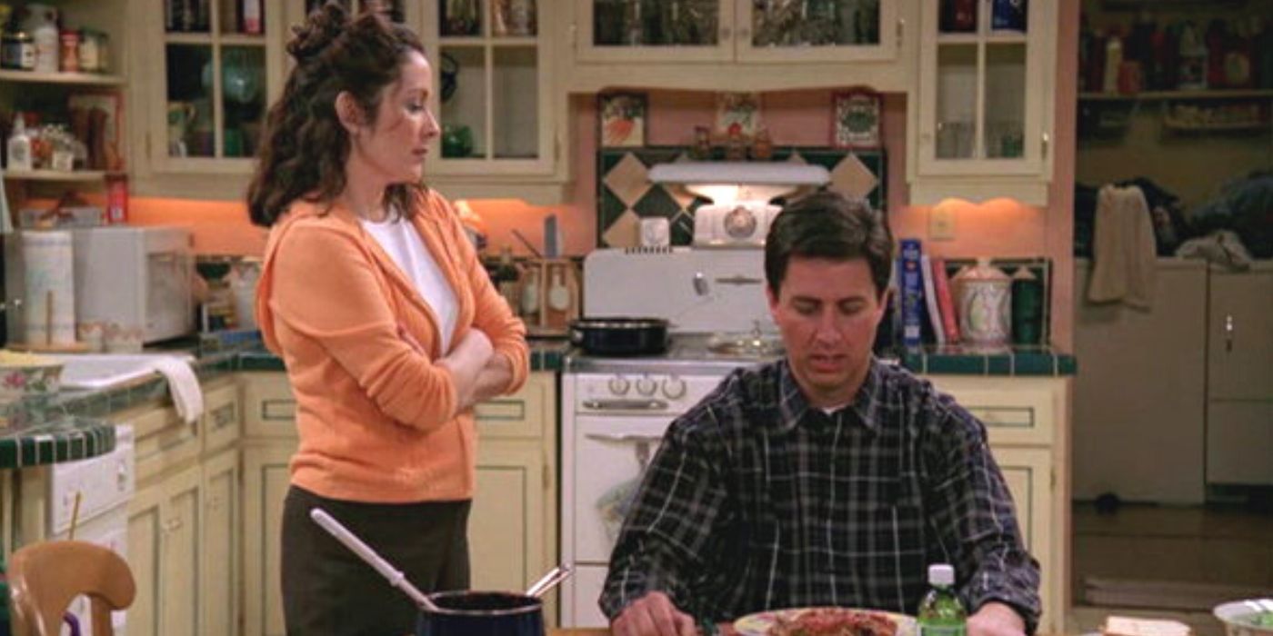 Patricia Heaton looking at Ray Ramano sitting at a table in Everybody Loves Raymond