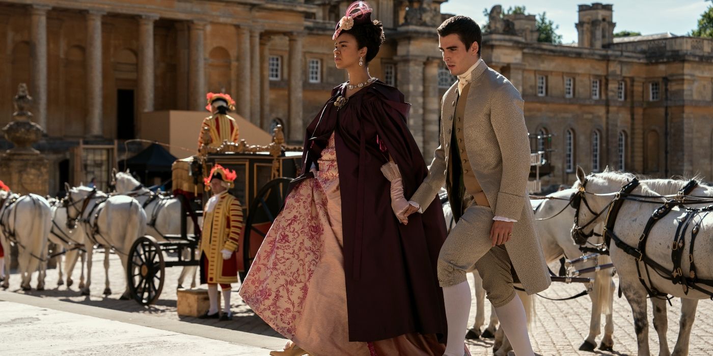 Queen Charlotte and King George walking hand-in-hand in Queen Charlotte.