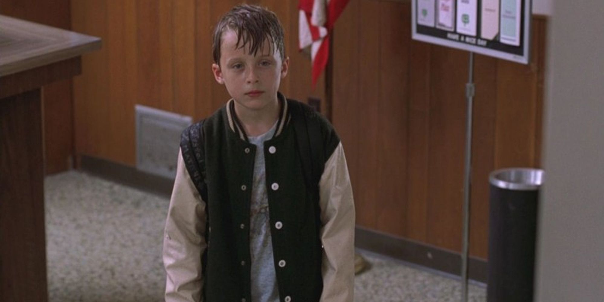 Rory Culkin in 'You Can Count On Me', wet in front of an American flag