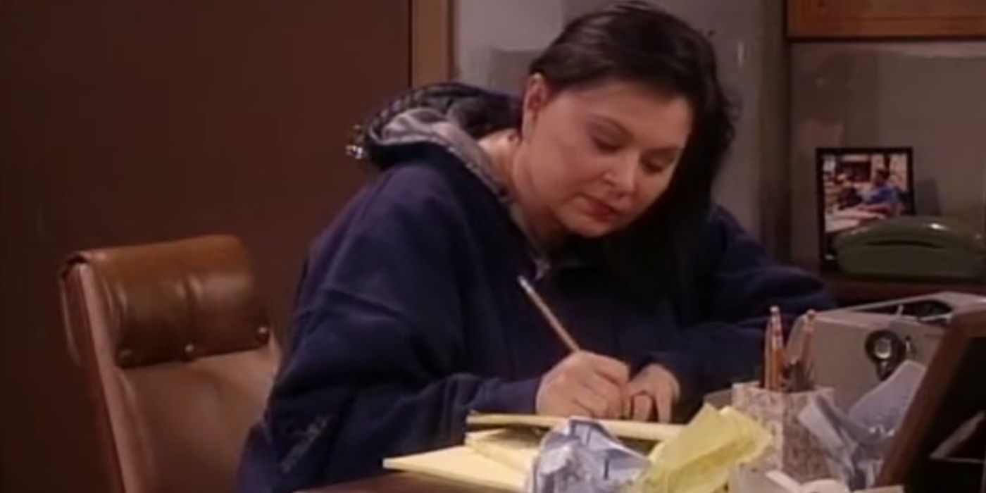 Roseanne Barr writing at her desk in the Roseanne series finale