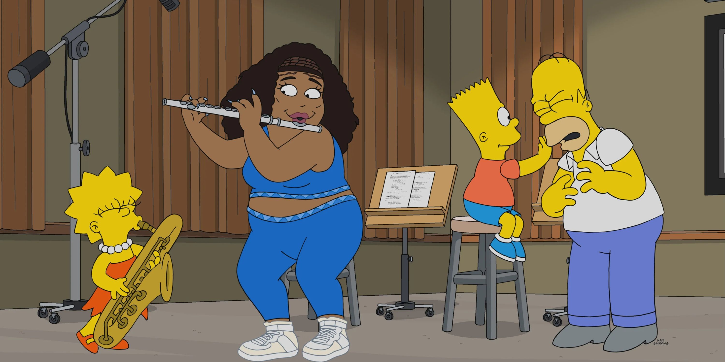 four people in a recording studio: from L to R, a girl playing a saxophone, a woman playing a flute, a boy sitting on a stool annoying his father