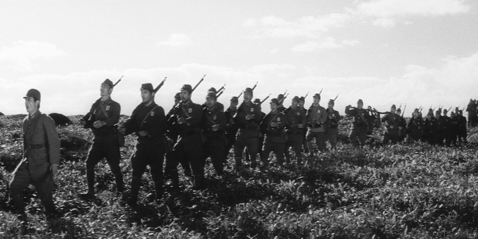 Soldiers marching across a grassy field in 'The Human Condition II: Road to Eternity'