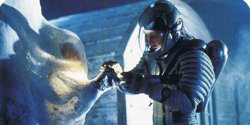 A man in an astronaut suit looking at a snow sculpture in Supernova