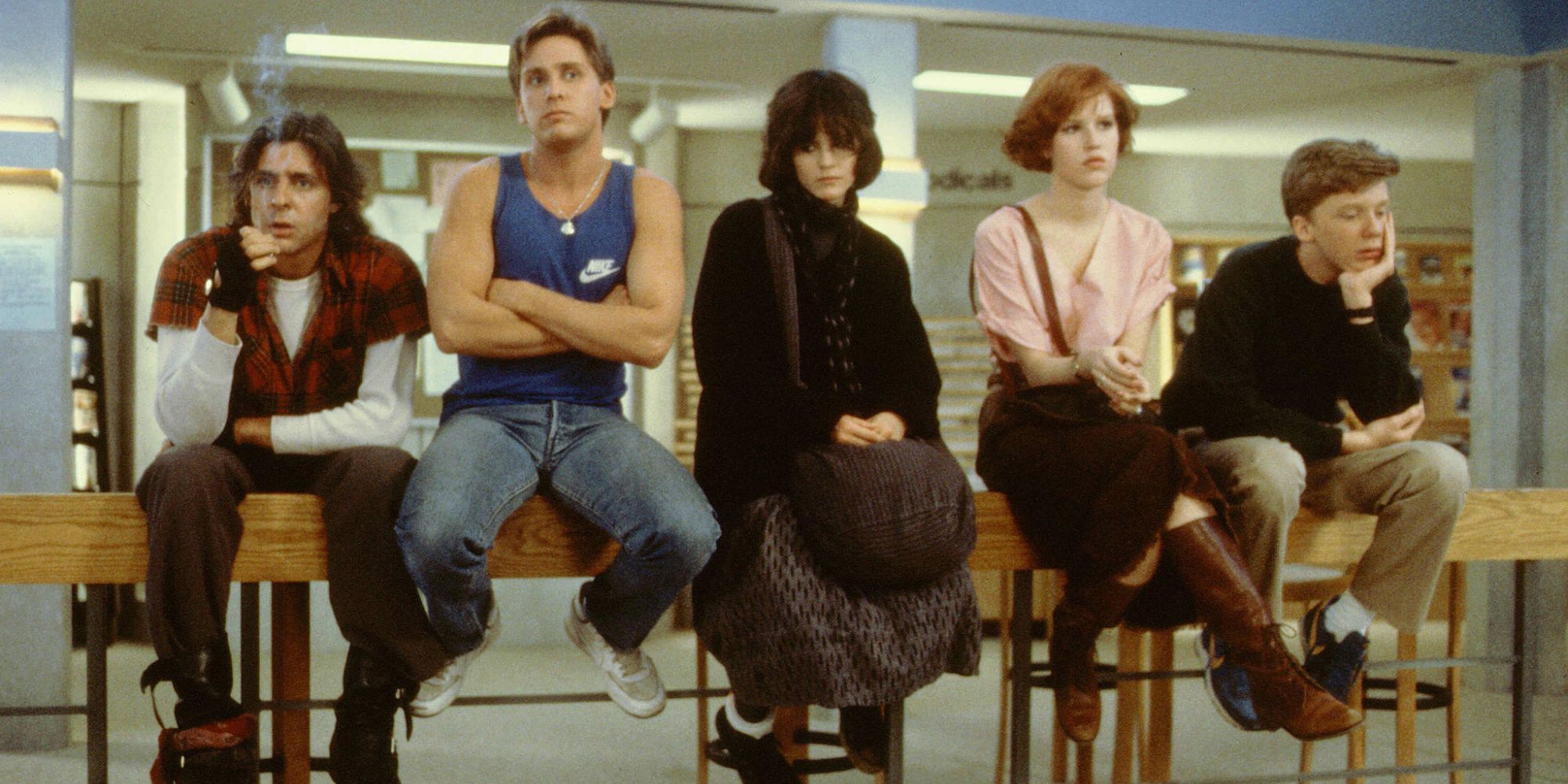 The main cast of The Breakfast Club’ sitting on a bannister side by side.