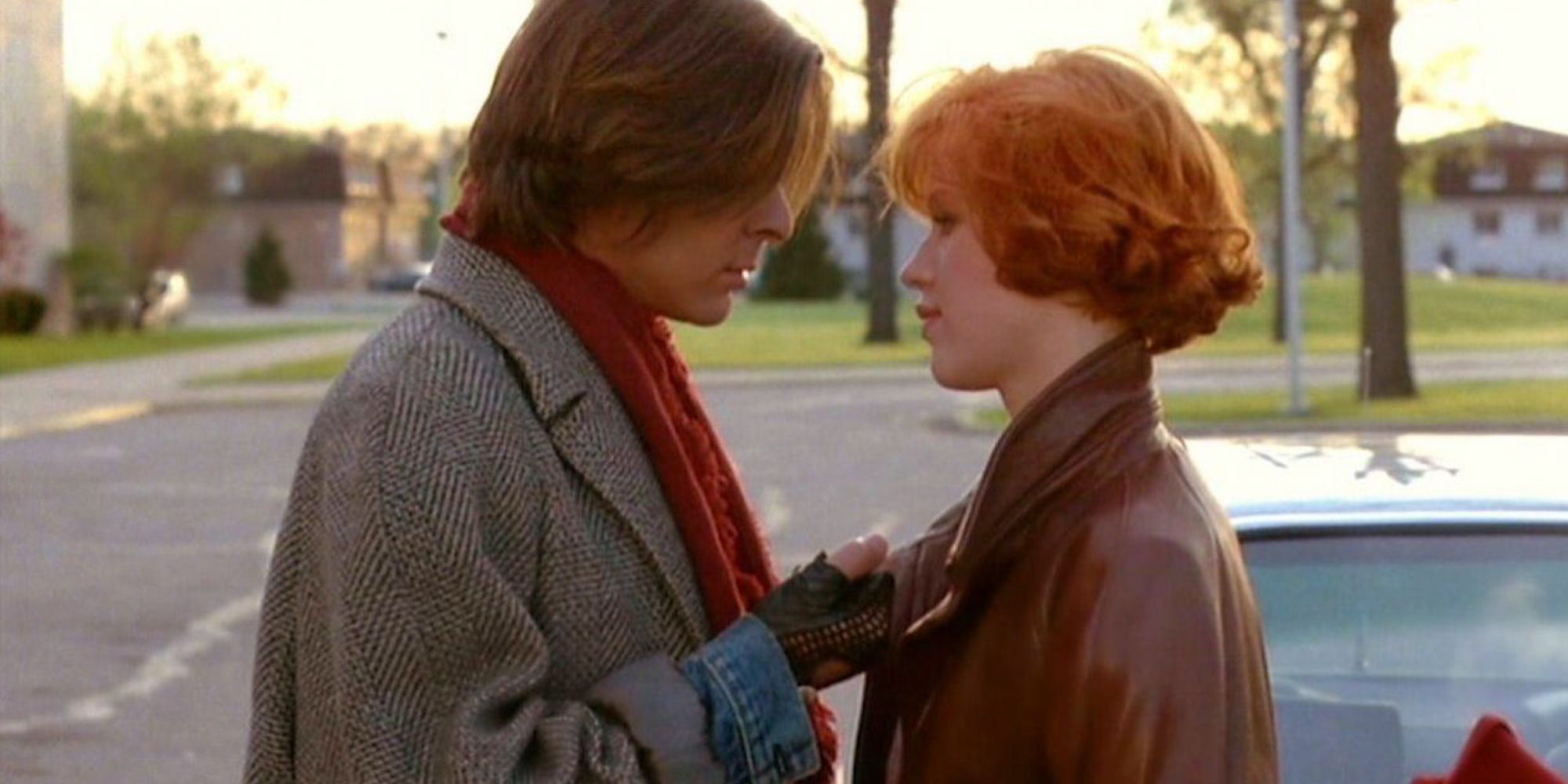 John (Judd Nelson) and Claire (Molly Ringwald) standing together in front of a car The Breakfast Club