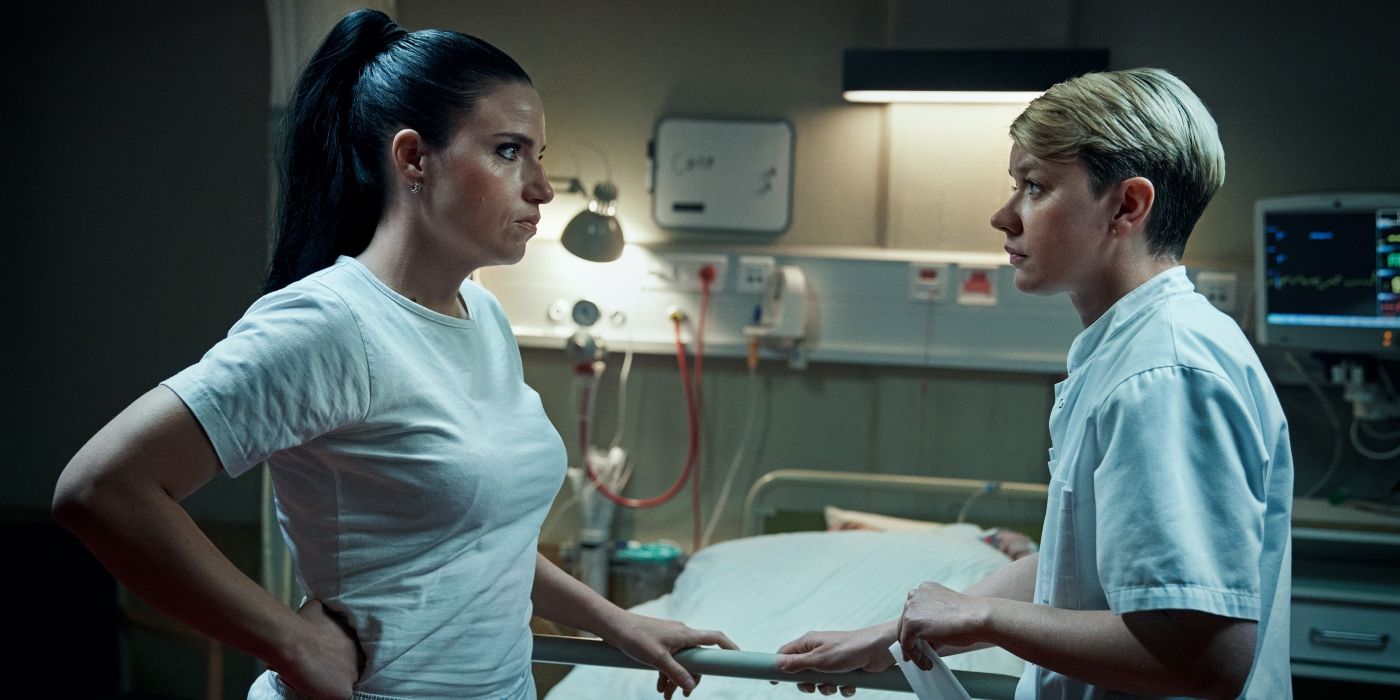 Josephine Park as Christina Aistrup and Fanny Louise Bernth as Pernille Kurzmann talking near a hospital bed in The Nurse. 