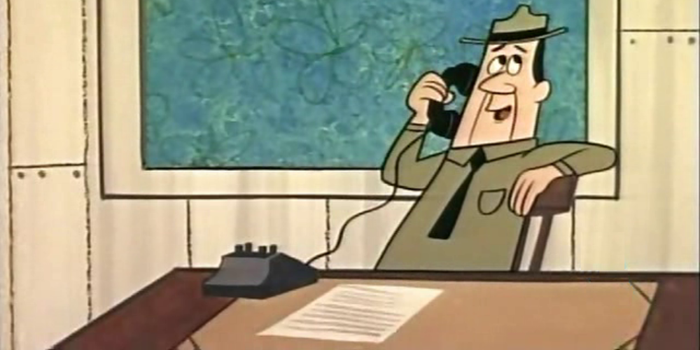 Ranger Smith talking on the phone in his office