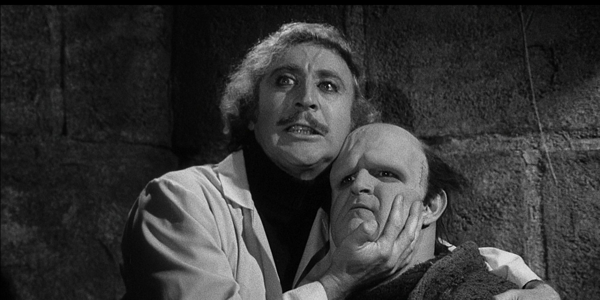 Gene Wilder as Dr. Frankenstein holding Peter Boyle as The Monster by the chin in Young Frankenstein
